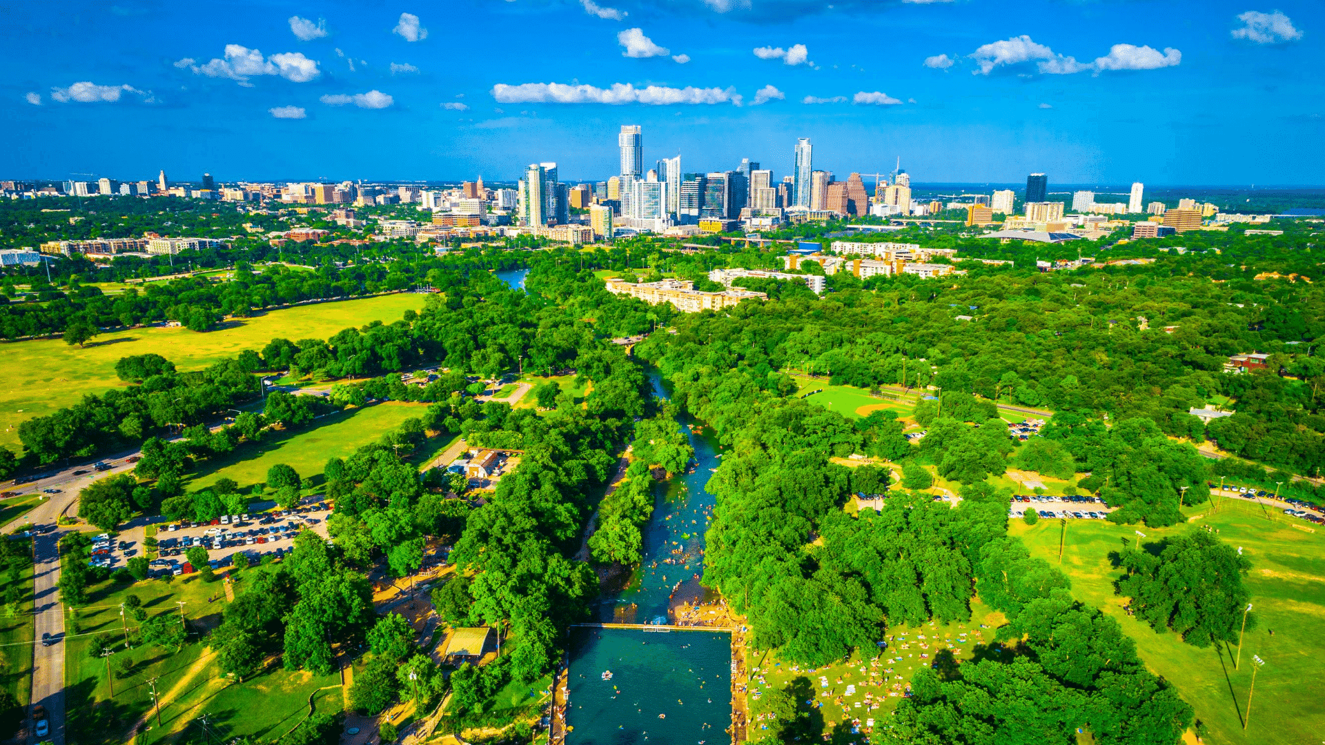 An over view of Austin tx showing all the greenery that the city offers and it's beautiful skyline of downtown.