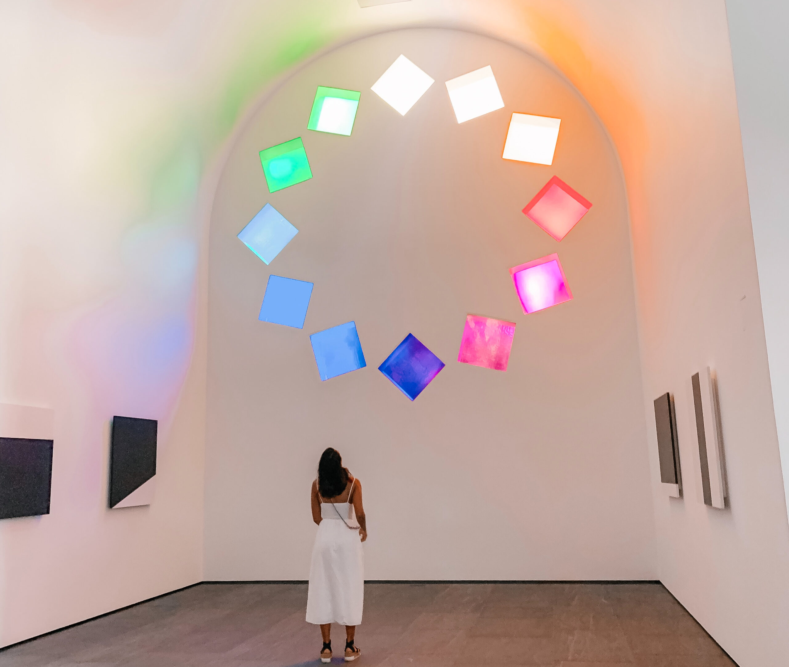 Image of a woman standing at one of the new installations in the Blanton Museum.