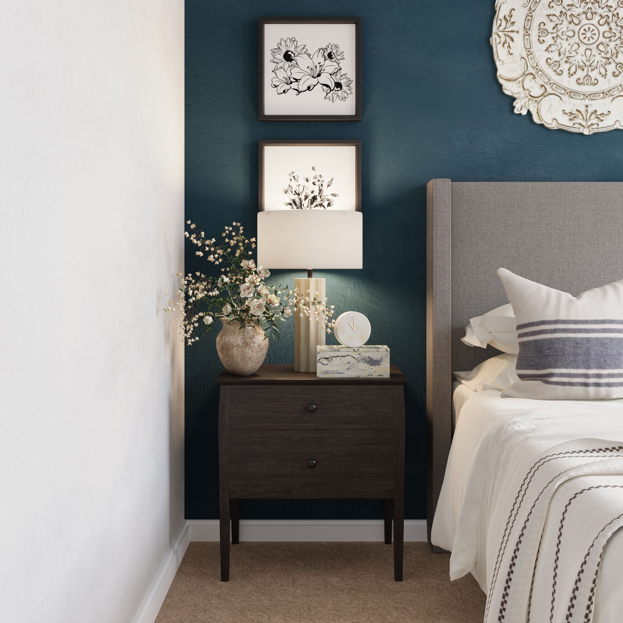 a cozy corner in a vacation home's bedroom with a grey bed frame, a dark,wooden nightstand with a gold nightstand lamp, small decoration, and wall art. 