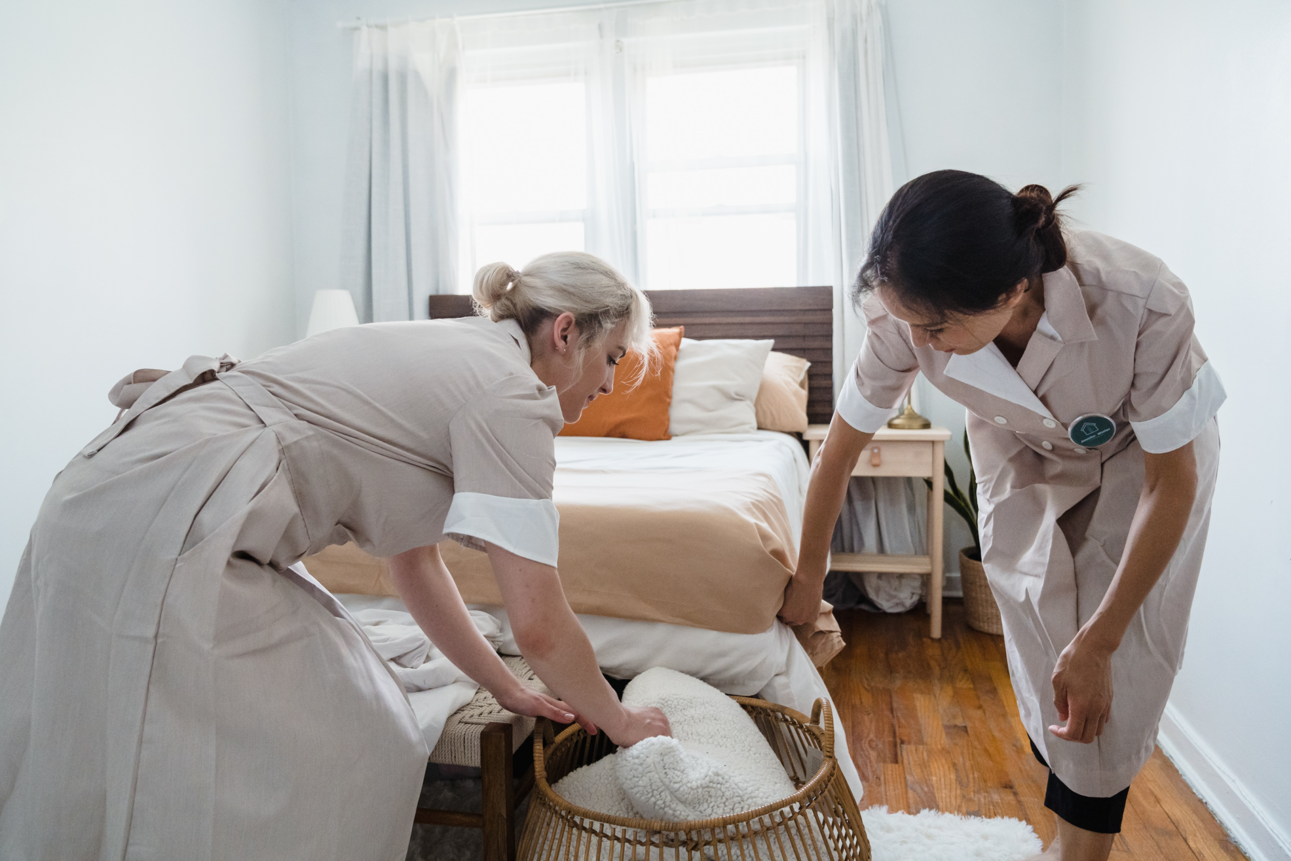 Image of two cleaners setting up a room