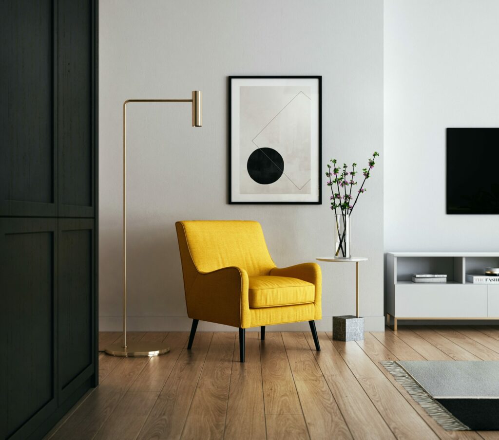 Image of a living room corner with a yellow accent chair.